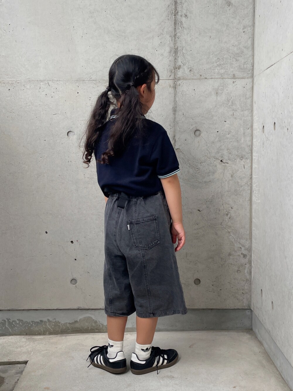 ブラック系のデニムパンツ、ブラック系のスニーカー、ブルー系のポロシャツを着用したキッズの夏コーディネートの2枚目の写真