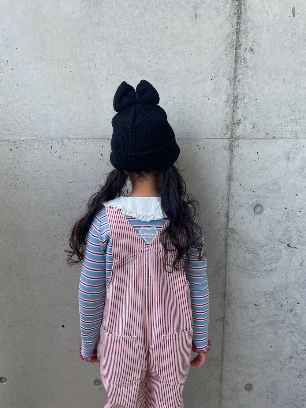 ブラック系のスニーカー、ブルー系のトップス、レッド系のオールインワン・サロペットを着用したキッズの夏コーディネートの5枚目の写真