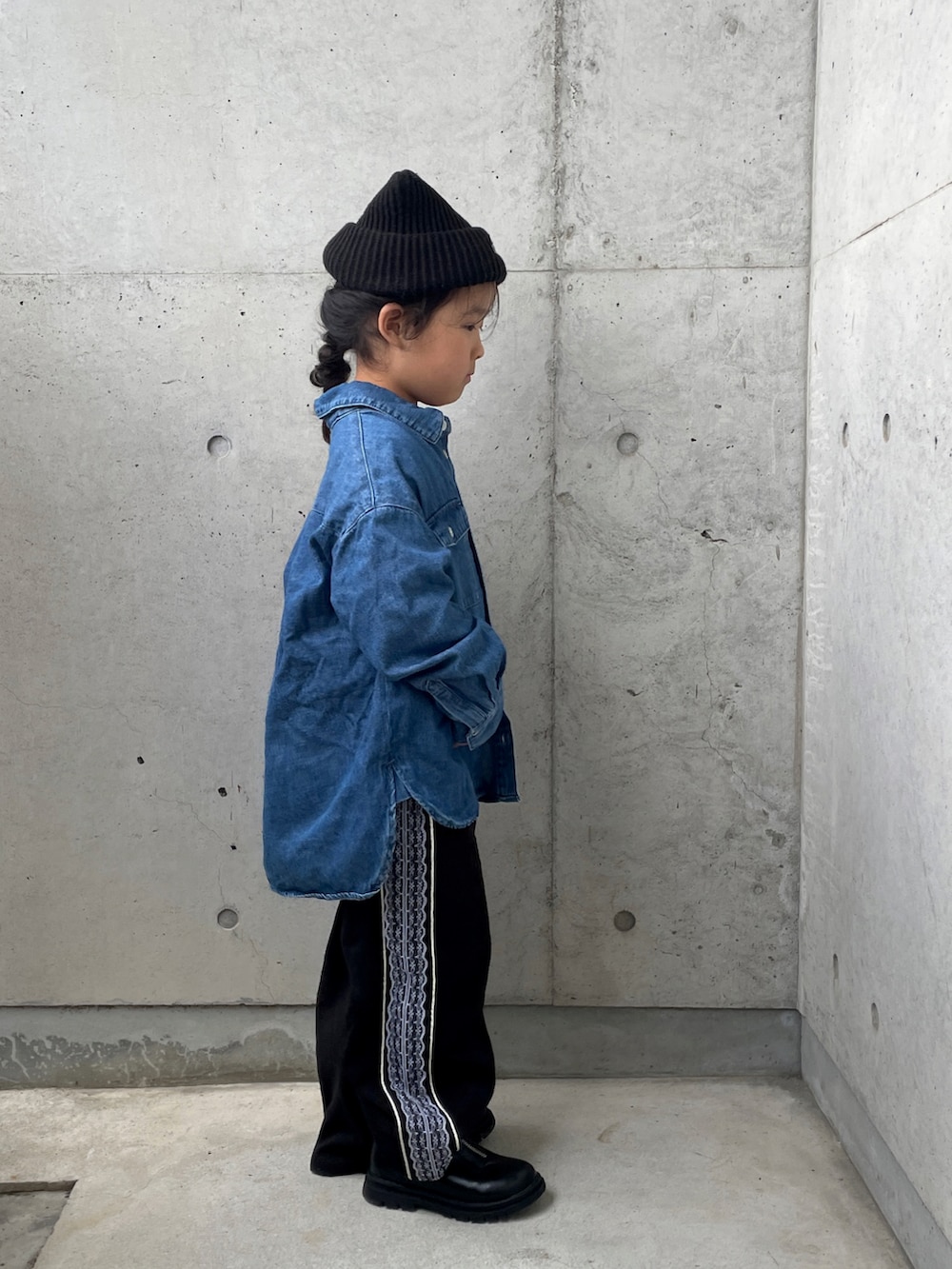 ブラック系のパンツ、ピンク系のニット/セーター、ブルー系のシャツ/ブラウスを着用したキッズの冬コーディネートの2枚目の写真