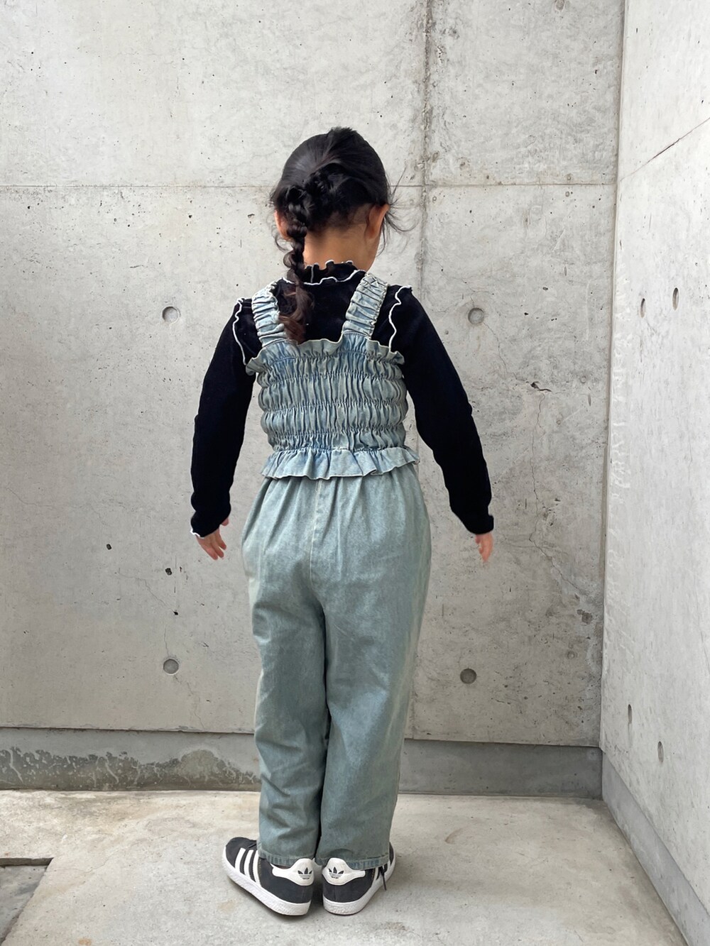 ブラック系のTシャツ/カットソー、ブルー系のオールインワン・サロペット、ブラック系のスニーカーを着用したキッズの春コーディネートの5枚目の写真