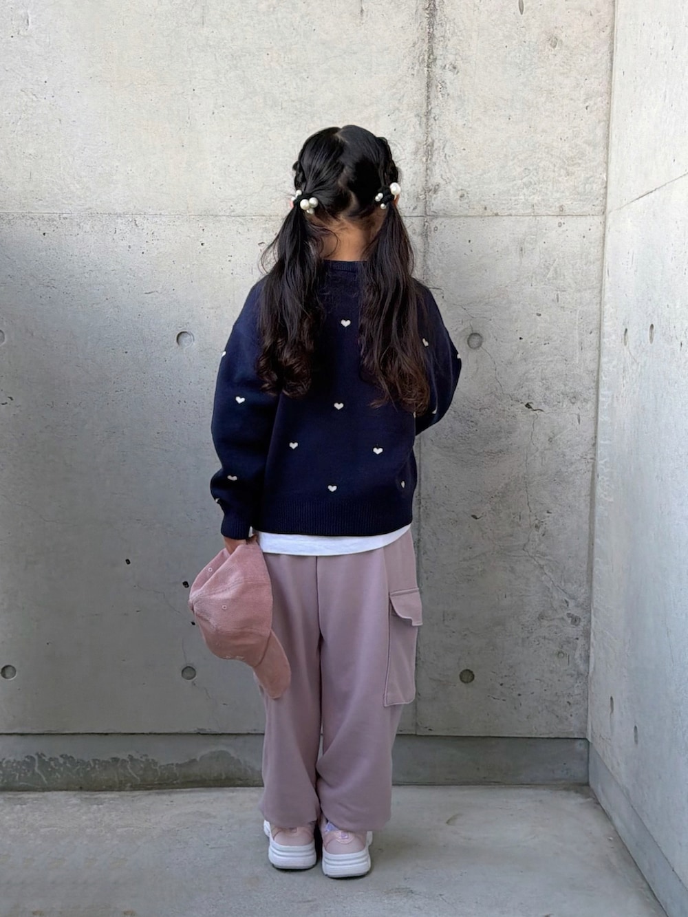 ピンク系のカーゴパンツ、ピンク系のスニーカー、ブルー系のニット/セーターを着用したキッズの冬コーディネートの4枚目の写真