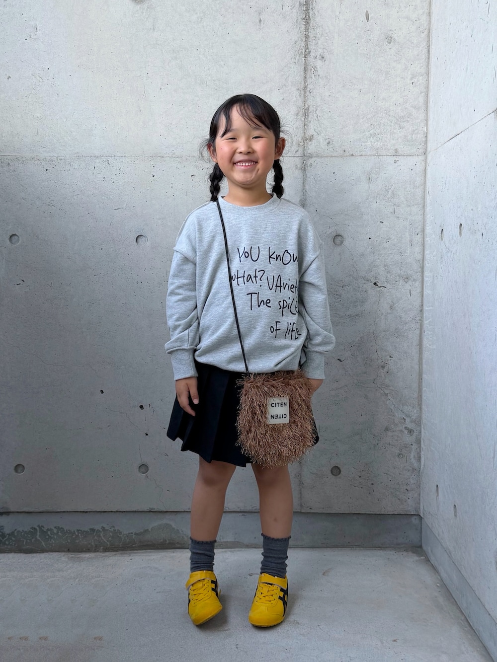 グレー系のTシャツ/カットソー、ベージュ系のミリタリージャケット、イエロー系のスニーカーを着用したキッズの秋コーディネートの4枚目の写真