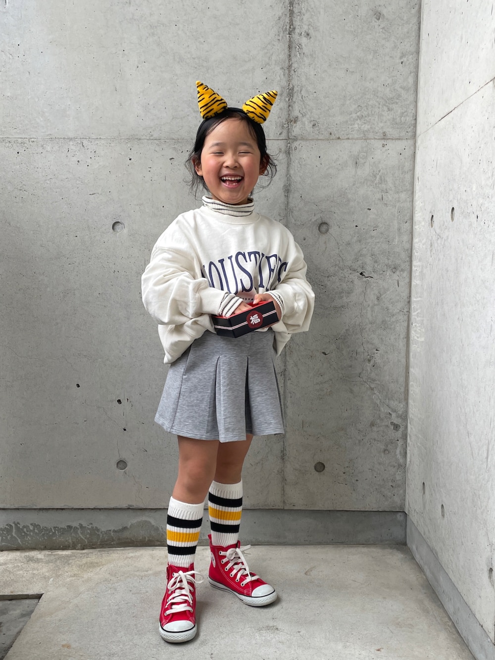 レッド系のスニーカー、ホワイト系のTシャツ/カットソー、ホワイト系のスウェットを着用したキッズの冬コーディネートの3枚目の写真