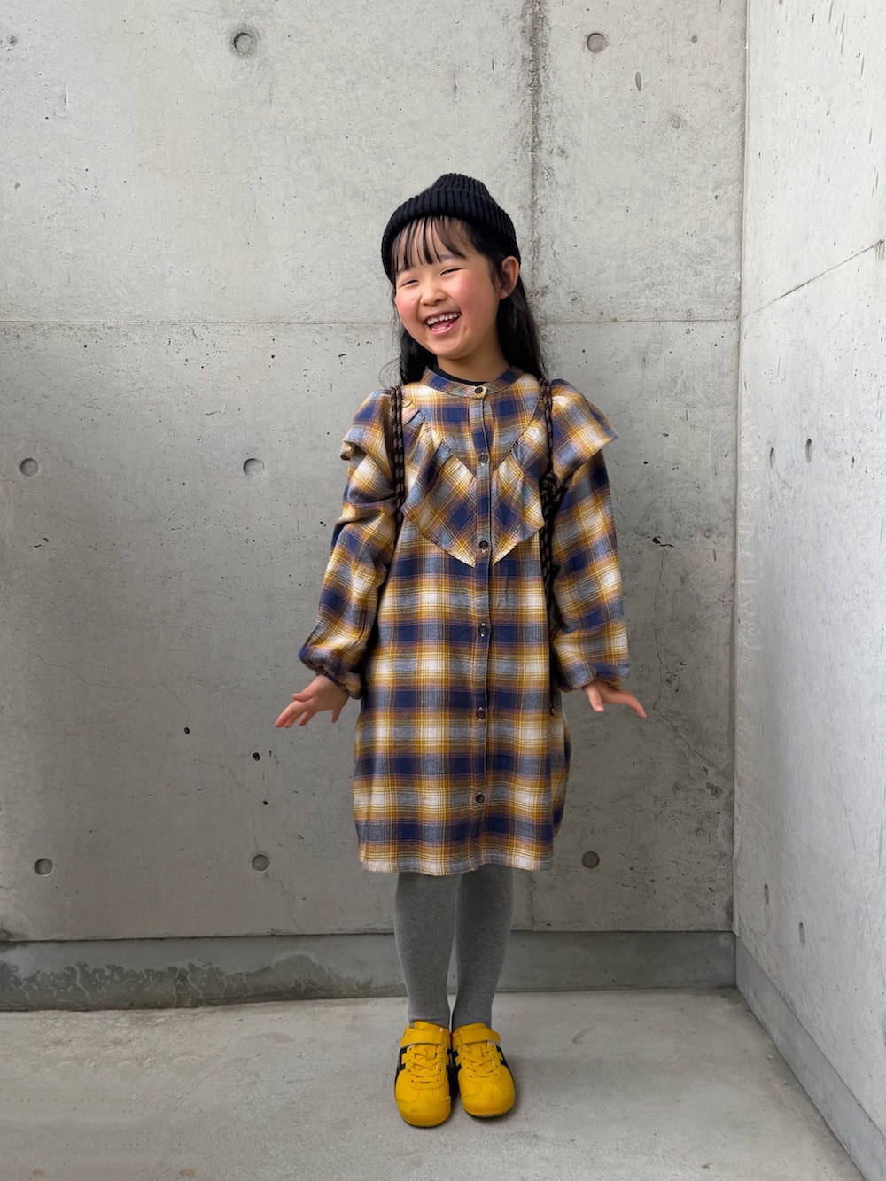 イエロー系のワンピース、イエロー系のスニーカー、ブラック系のバックパック/リュックを着用したキッズの春コーディネートの5枚目の写真