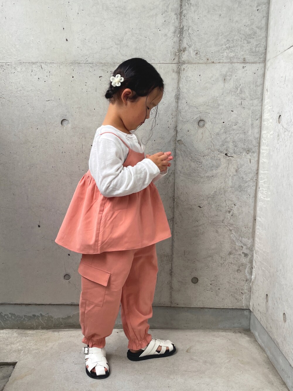 オレンジ系のTシャツ/カットソー、オレンジ系のその他パンツ、ホワイト系のサンダルを着用したキッズの春コーディネートの4枚目の写真