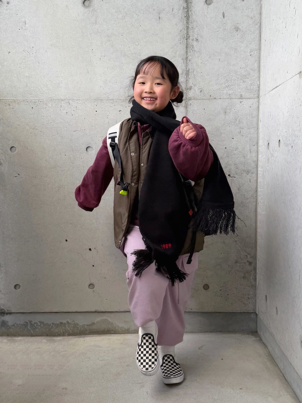 ホワイト系のTシャツ/カットソー、ピンク系のカーゴパンツ、ブラック系のスリッポンを着用したキッズの冬コーディネートの2枚目の写真