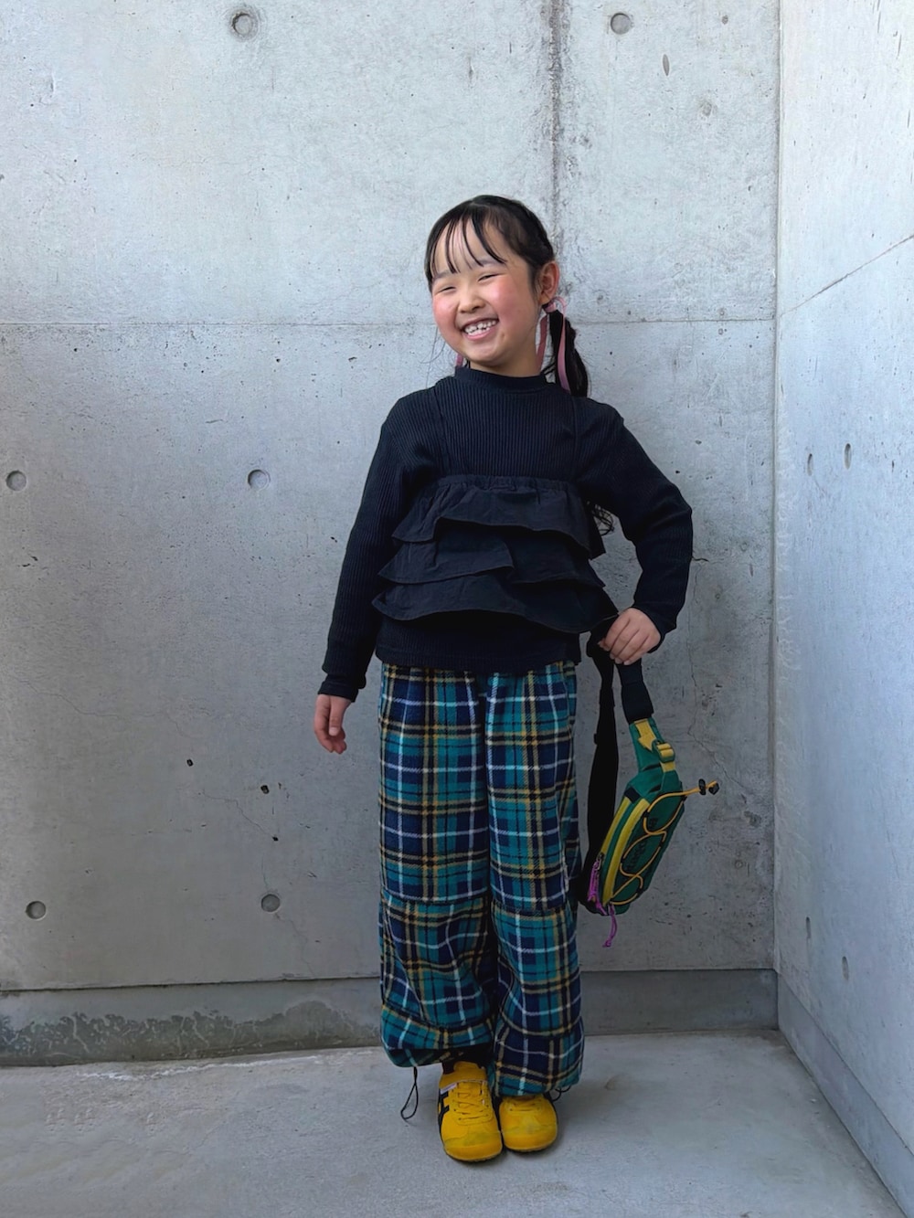 イエロー系のスニーカー、ブラック系のTシャツ/カットソー、グリーン系のパンツを着用したキッズの春コーディネートの5枚目の写真