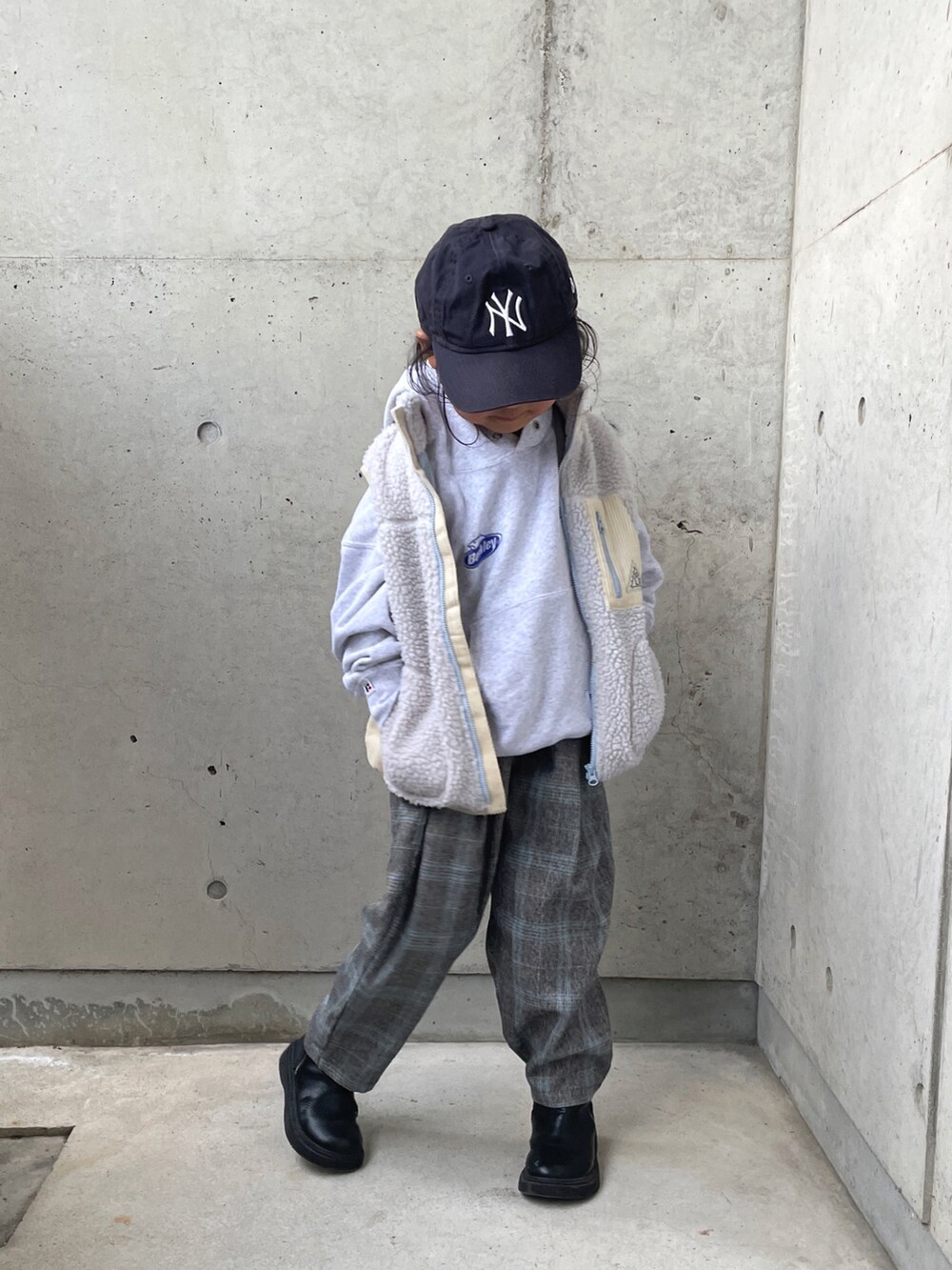 グレー系のベスト、グレー系のスウェット、グレー系のパンツを着用したキッズの冬コーディネートの4枚目の写真