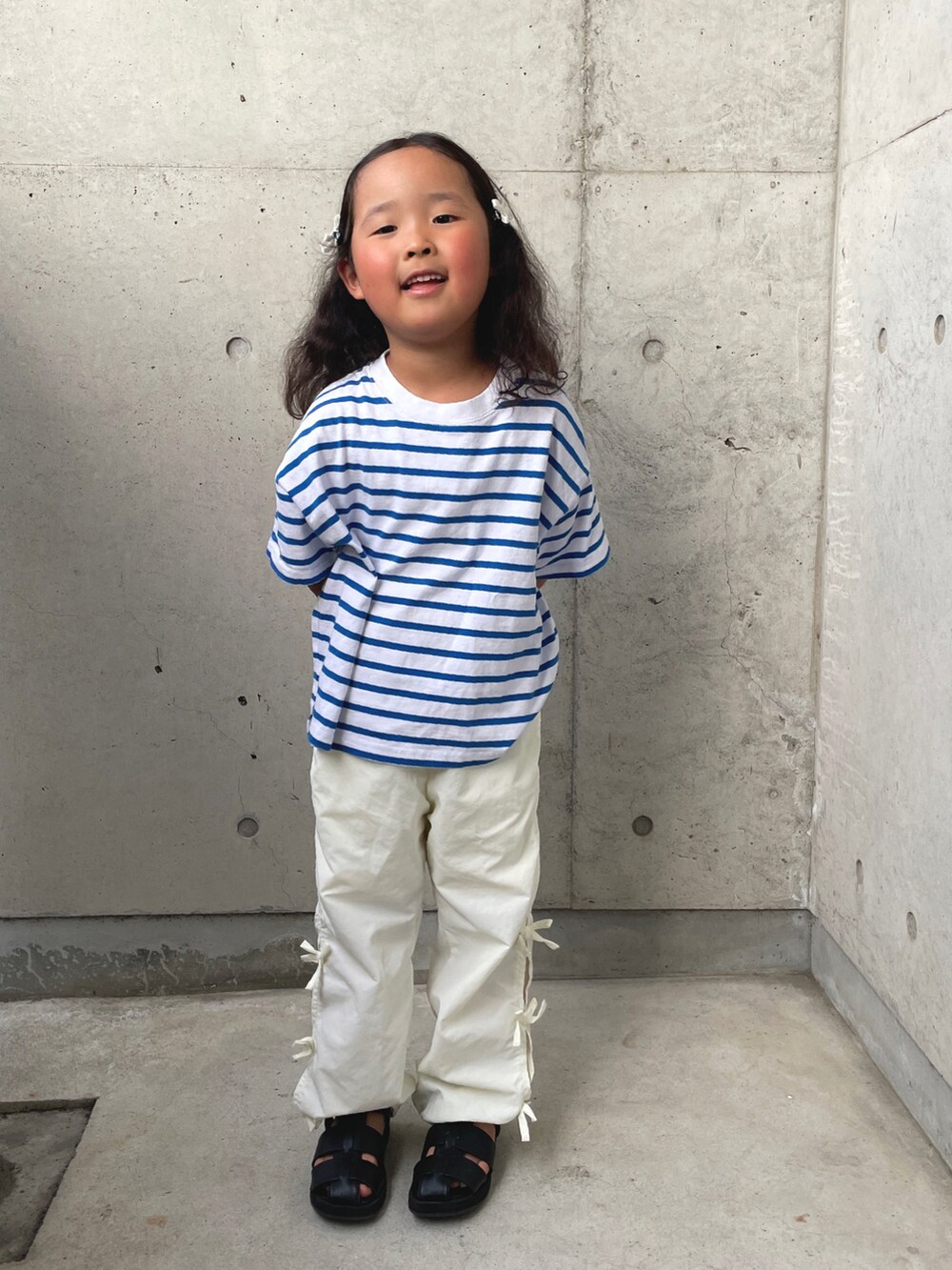 ブルー系のTシャツ/カットソー、ホワイト系のその他パンツ、ブラック系のサンダルを着用したキッズの春コーディネートの3枚目の写真