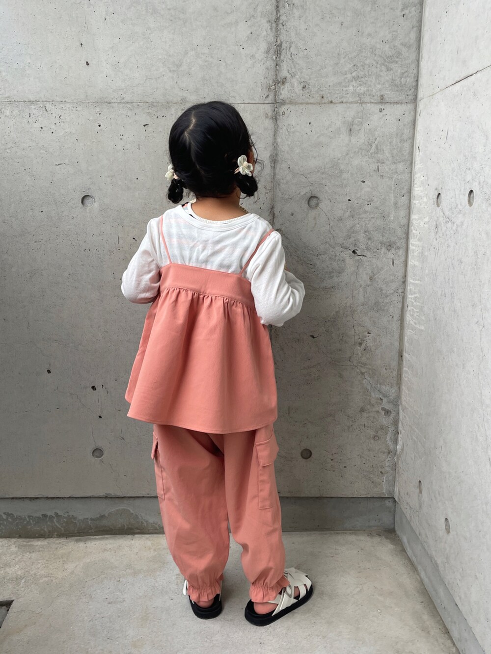 オレンジ系のTシャツ/カットソー、オレンジ系のその他パンツ、ホワイト系のサンダルを着用したキッズの春コーディネートの5枚目の写真