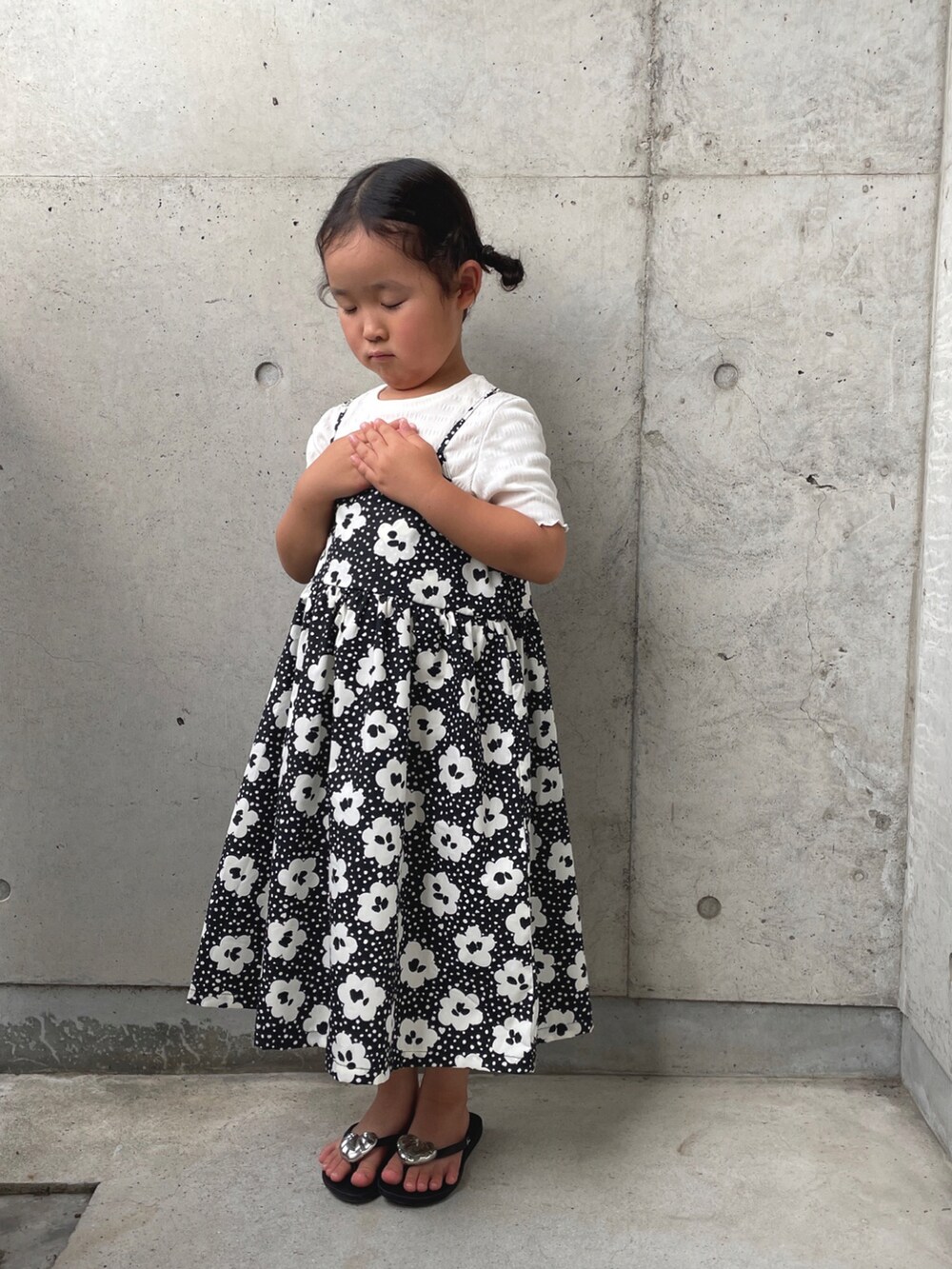 ブラック系のサンダル、ブラック系のワンピース、パープル系のTシャツ/カットソーを着用したキッズの夏コーディネートの3枚目の写真