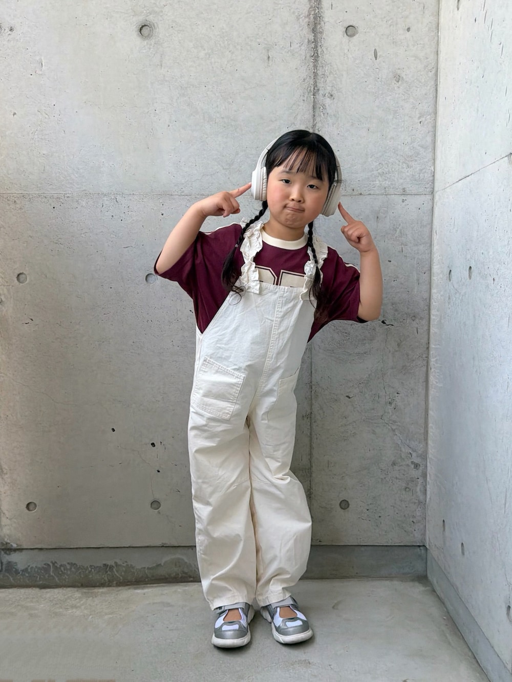 ホワイト系のサロペット/オーバーオール、レッド系のTシャツ/カットソー、シルバー系のスニーカーを着用したキッズの春コーディネートの4枚目の写真