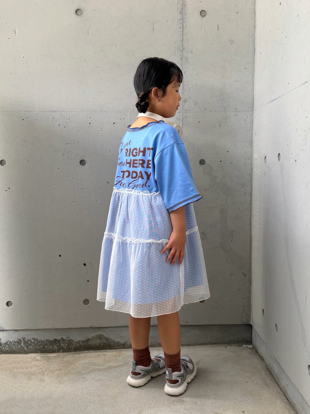 ブルー系のワンピース、シルバー系のスニーカー、ベージュ系のヘッドフォン/イヤホンを着用したキッズの夏コーディネートの4枚目の写真