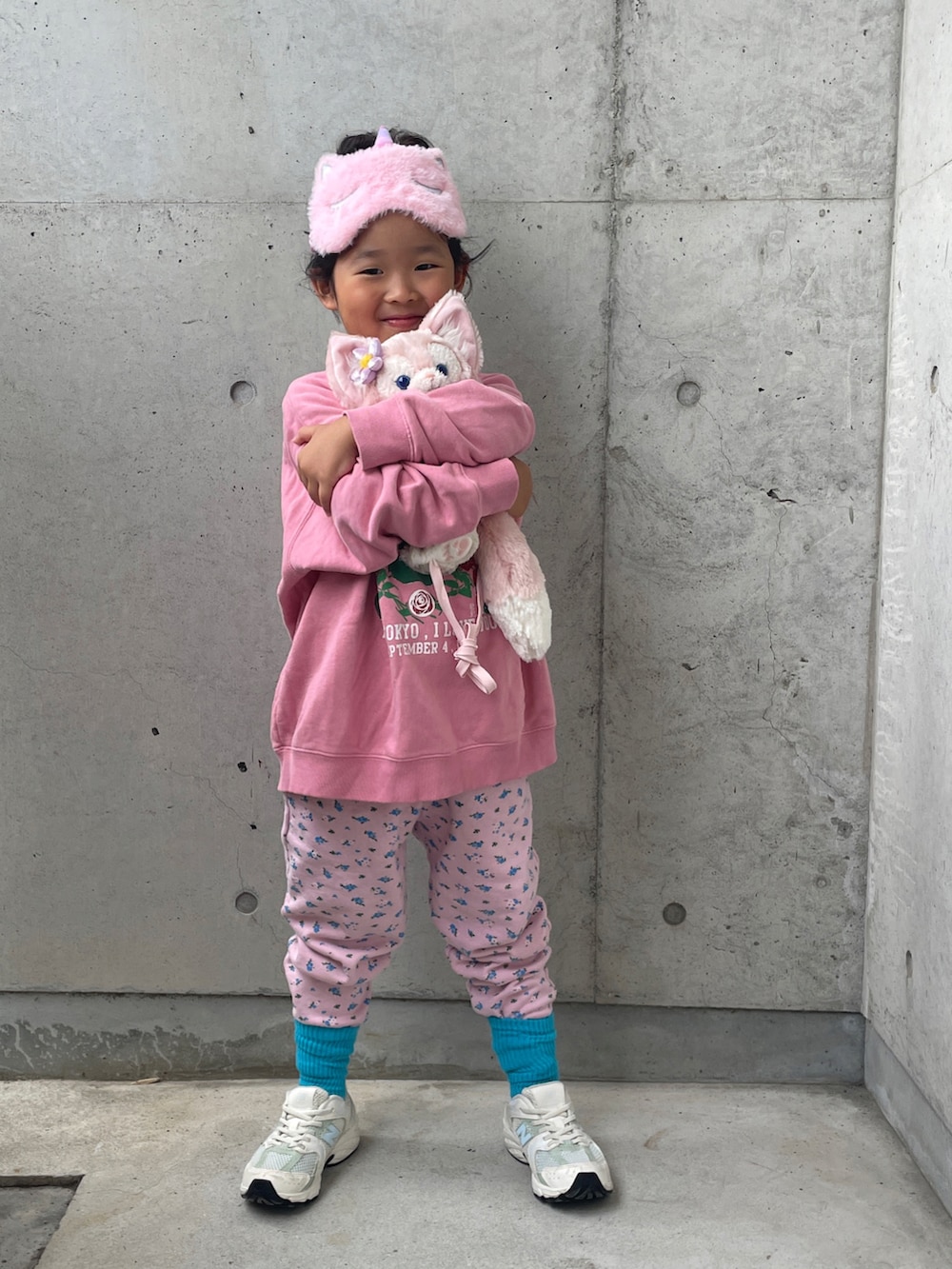 ピンク系のスウェット、ピンク系のその他パンツ、ホワイト系のスニーカーを着用したキッズの秋コーディネートの3枚目の写真