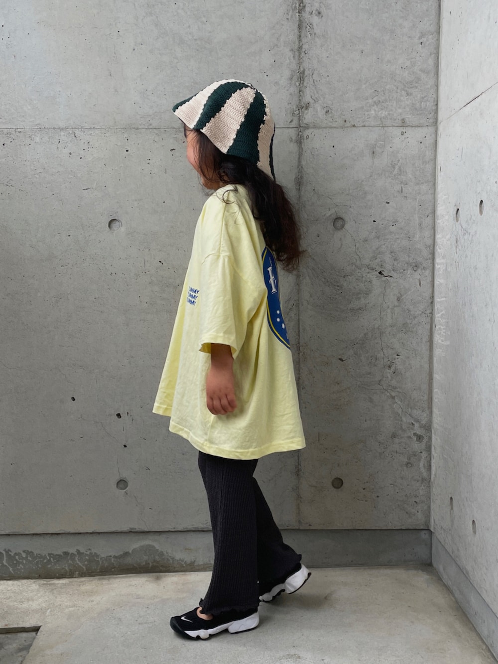 イエロー系のTシャツ/カットソー、グレー系のその他パンツ、ブラック系のスニーカーを着用したキッズの春コーディネートの3枚目の写真