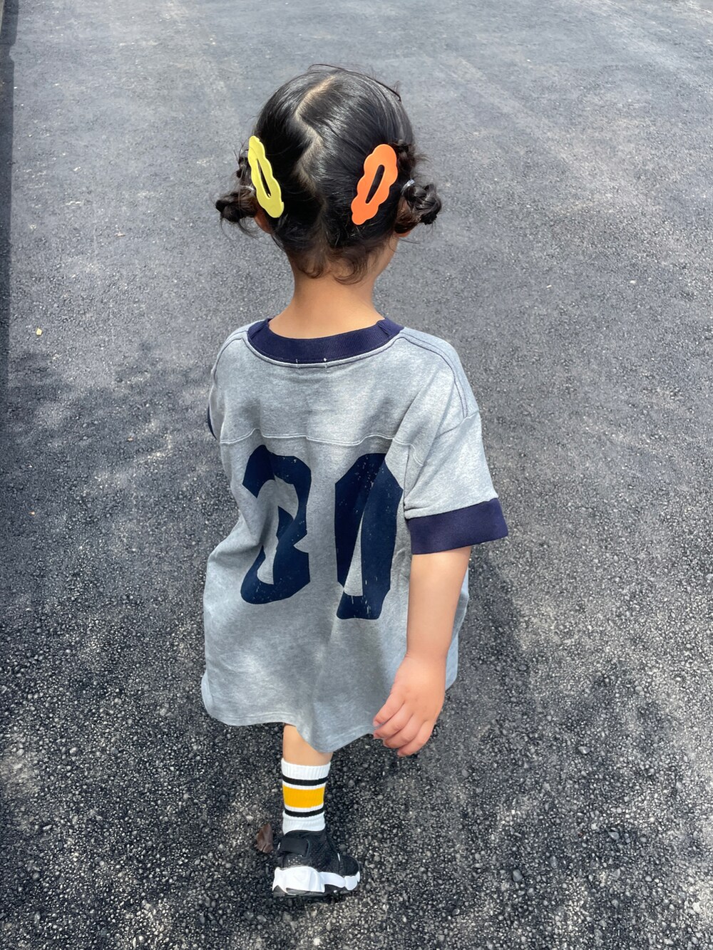 グレー系のワンピース、ブラック系のスニーカー、ブラック系のソックス/靴下を着用したキッズの春コーディネートの5枚目の写真
