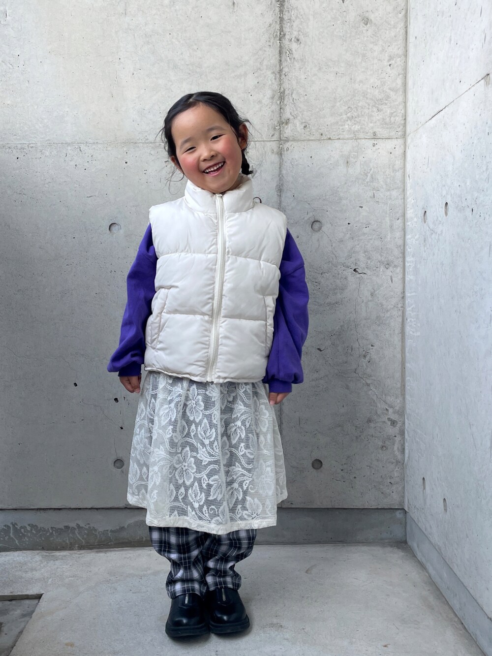 ホワイト系のスカート、パープル系のTシャツ/カットソー、ブラック系のブーツを着用したキッズの冬コーディネートの5枚目の写真