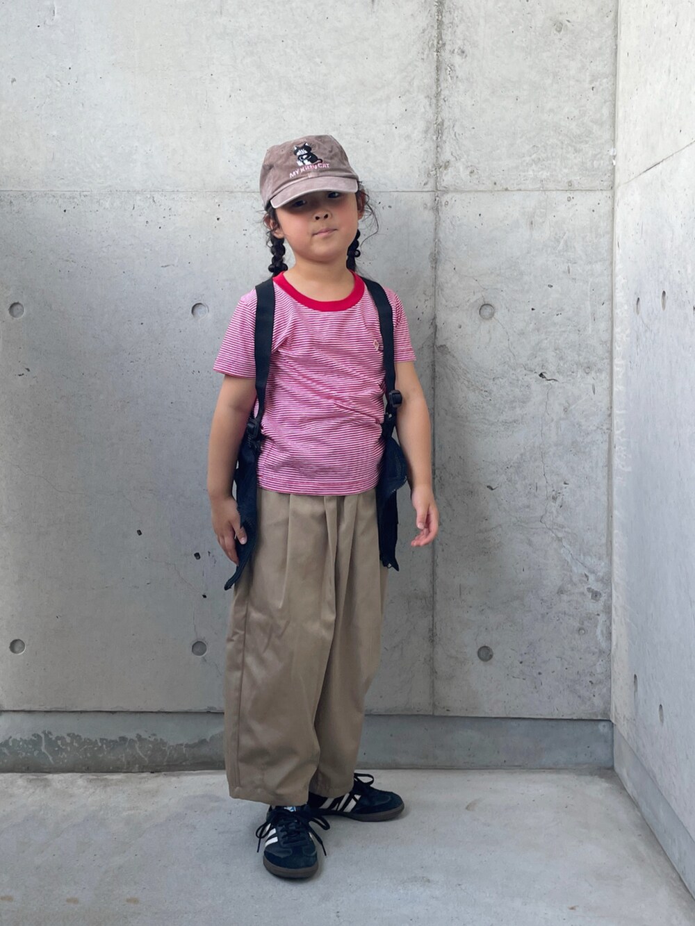 イエロー系のその他パンツ、ブラック系のスニーカー、レッド系のTシャツ/カットソーを着用したキッズの秋コーディネートの3枚目の写真