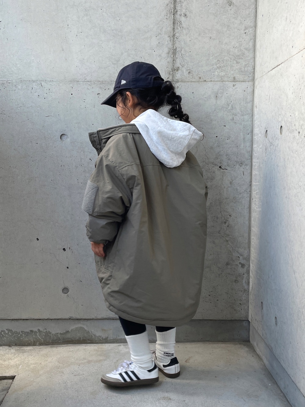 グリーン系のブルゾン、ホワイト系のTシャツ/カットソー、グレー系のスウェットを着用したキッズの冬コーディネートの2枚目の写真