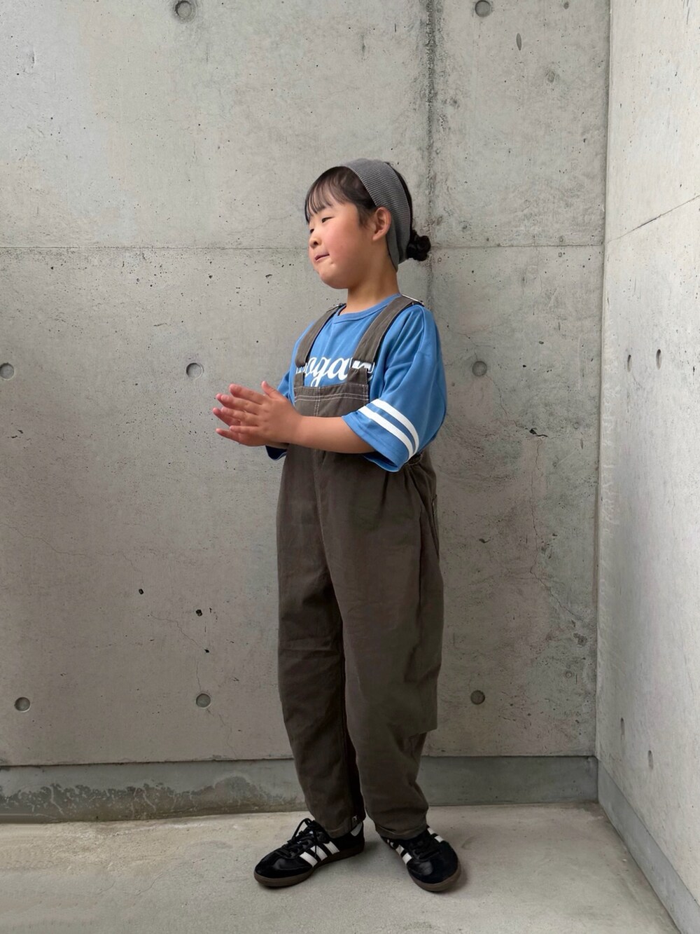 ブラック系のスニーカー、ブルー系のTシャツ/カットソー、グレー系のサロペット/オーバーオールを着用したキッズの春コーディネートの2枚目の写真