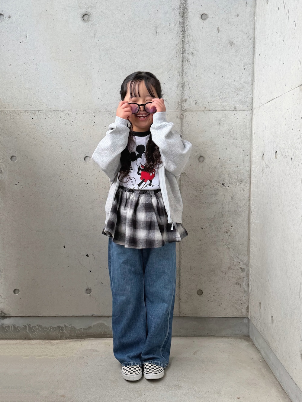 ブラック系のスカート、ブラック系のスリッポン、ホワイト系のトップスを着用したキッズの春コーディネートの3枚目の写真