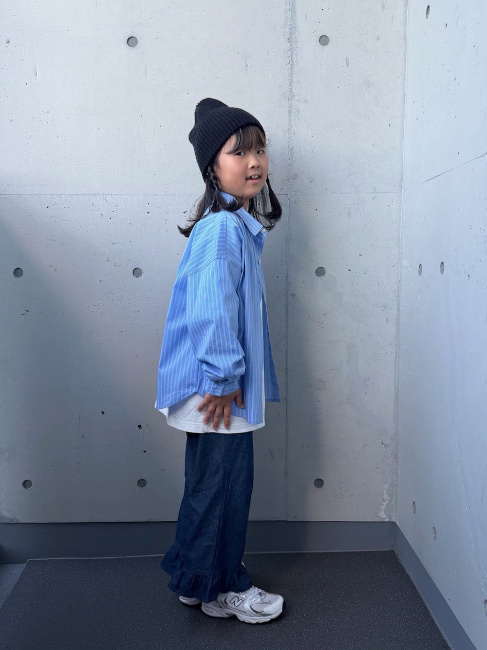 ブルー系のデニムパンツ、ホワイト系のスニーカー、ブルー系のシャツ/ブラウスを着用したキッズの秋コーディネートの2枚目の写真