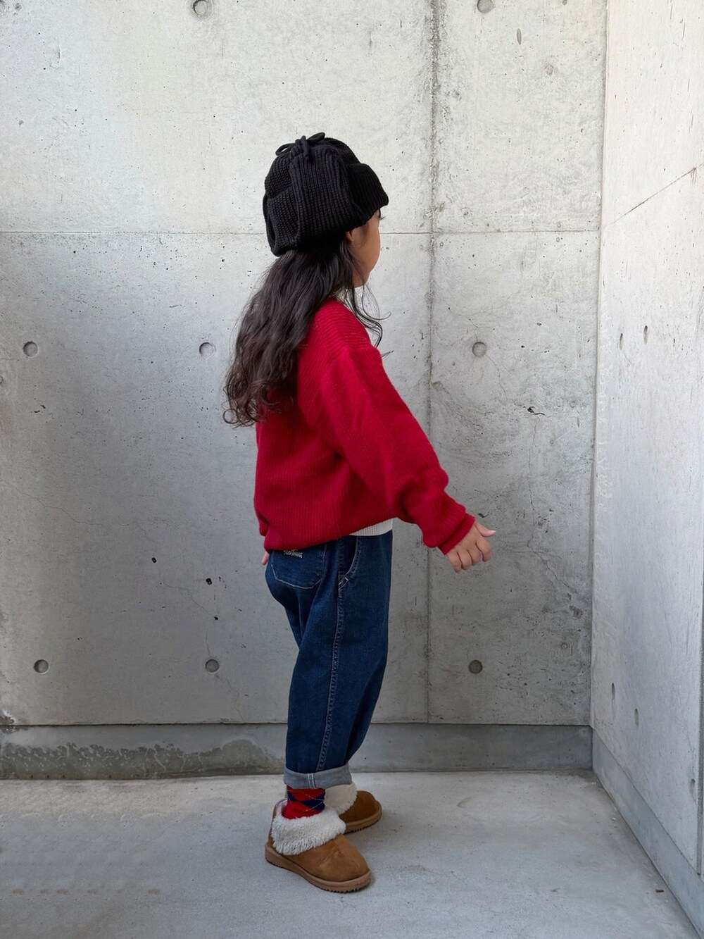 ホワイト系のニット/セーター、ブラウン系のブーツ、ブルー系のデニムパンツを着用したキッズの秋コーディネートの5枚目の写真