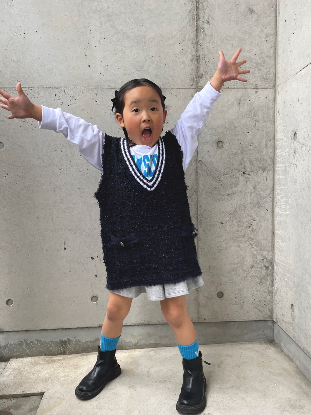 ブルー系のTシャツ/カットソー、グレー系のスカート、ブラック系のブーツを着用したキッズの春コーディネートの4枚目の写真