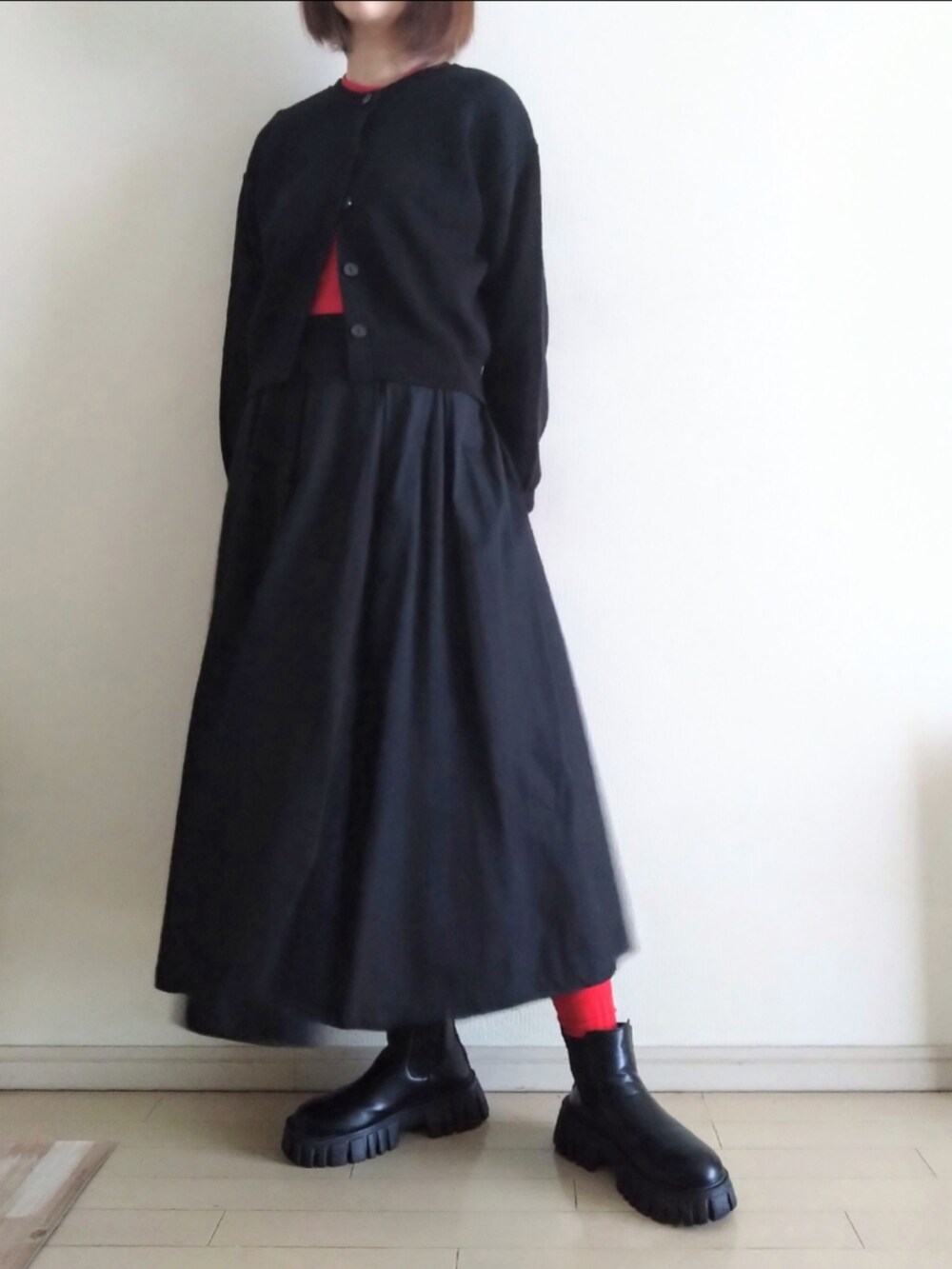 ブルー系のデニムジャケット、ブラック系のカーディガン/ボレロ、レッド系のニット/セーターを着用したレディースの秋コーディネートの2枚目の写真