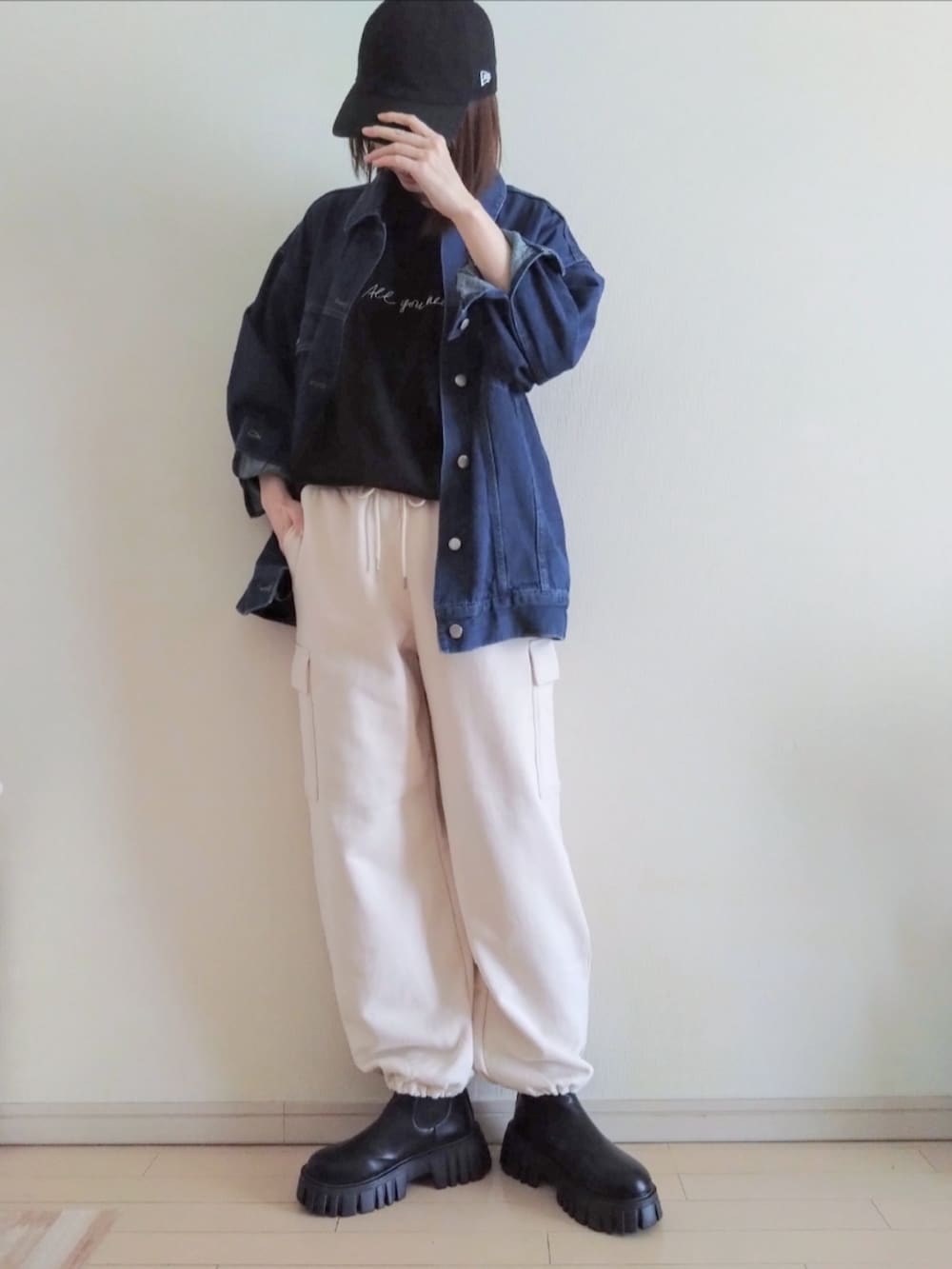 ホワイト系のカーゴパンツ、ブラック系のTシャツ/カットソー、ブルー系のデニムジャケットを着用したレディースの春コーディネートの2枚目の写真