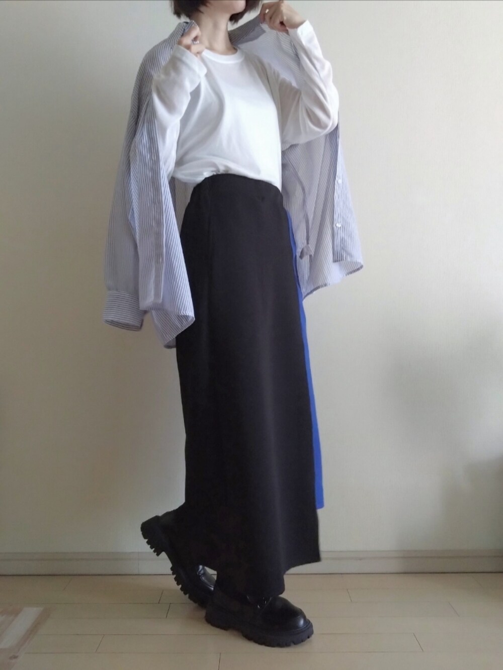 ブルー系のシャツ/ブラウス、ホワイト系のTシャツ/カットソー、ブラック系のスカートを着用したレディースの春コーディネートの2枚目の写真