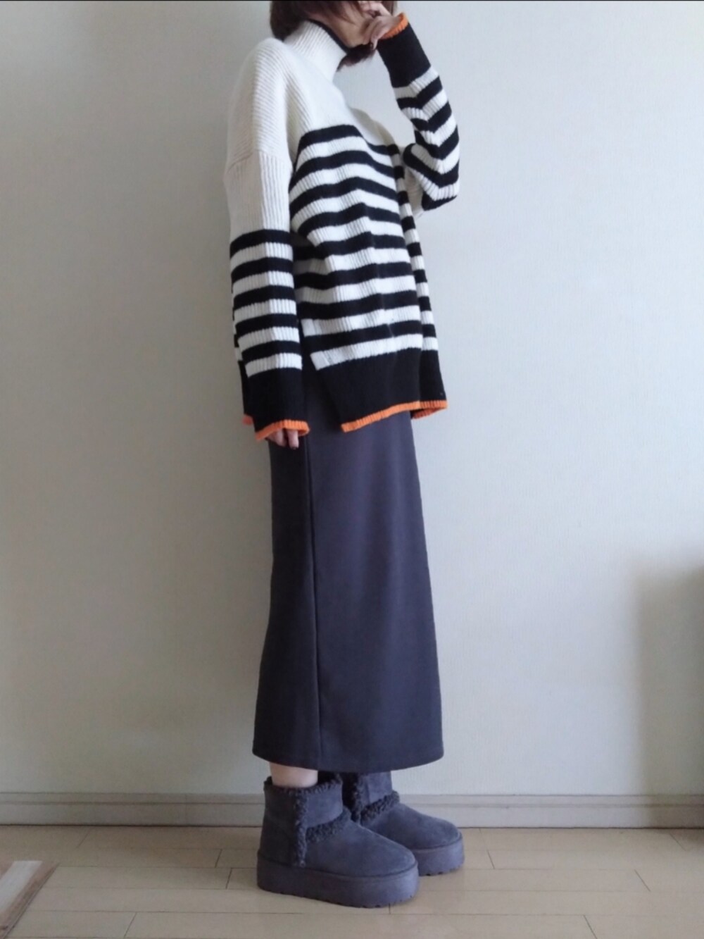 ブルー系のデニムジャケット、ホワイト系のニット/セーター、グレー系のスカートを着用したレディースの冬コーディネートの3枚目の写真