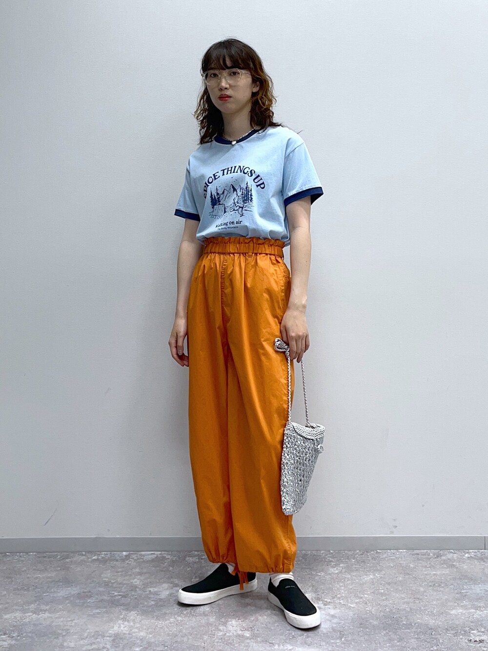 ブルー系のTシャツ/カットソー、オレンジ系のその他パンツ、グレー系のショルダーバッグを着用したレディースの春コーディネートの4枚目の写真