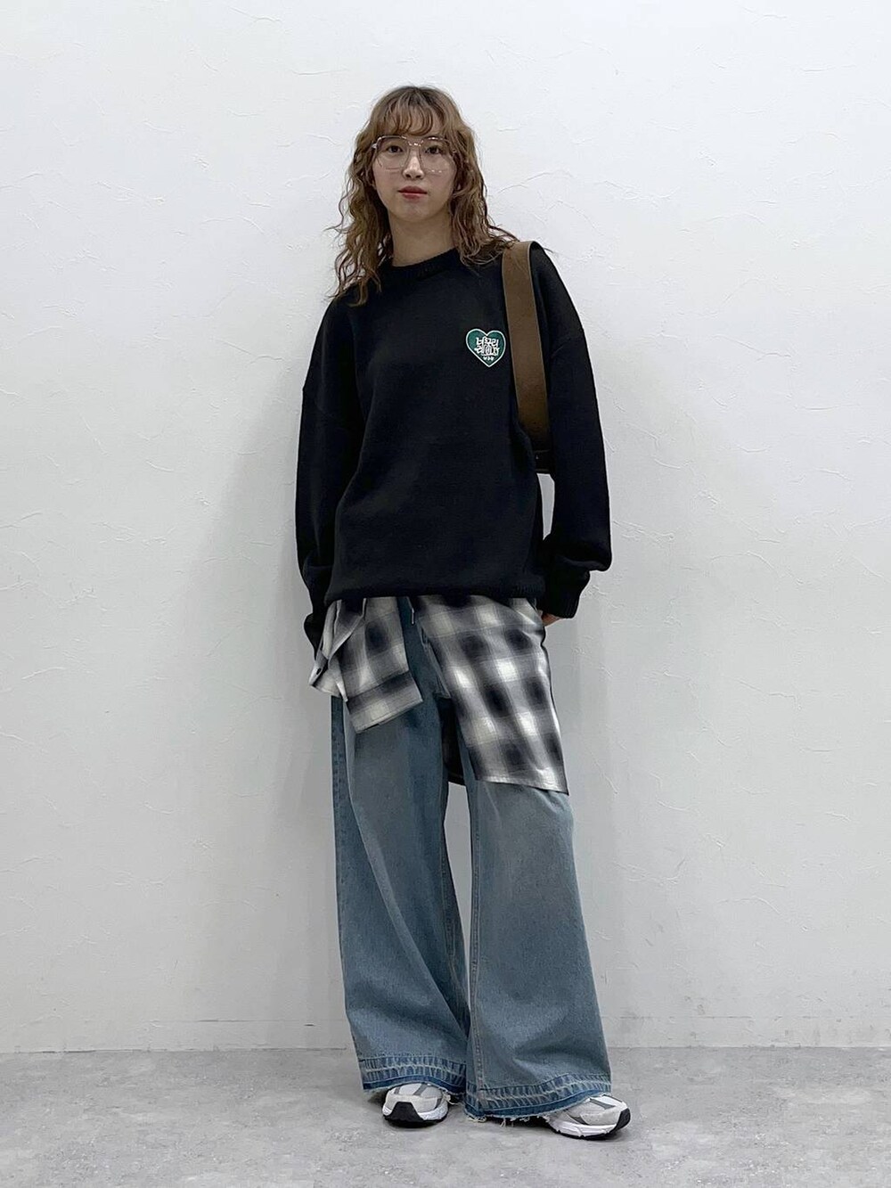 ブラック系のシャツ/ブラウス、ブルー系のデニムパンツ、ブラック系のニット/セーターを着用したレディースの秋コーディネートの2枚目の写真