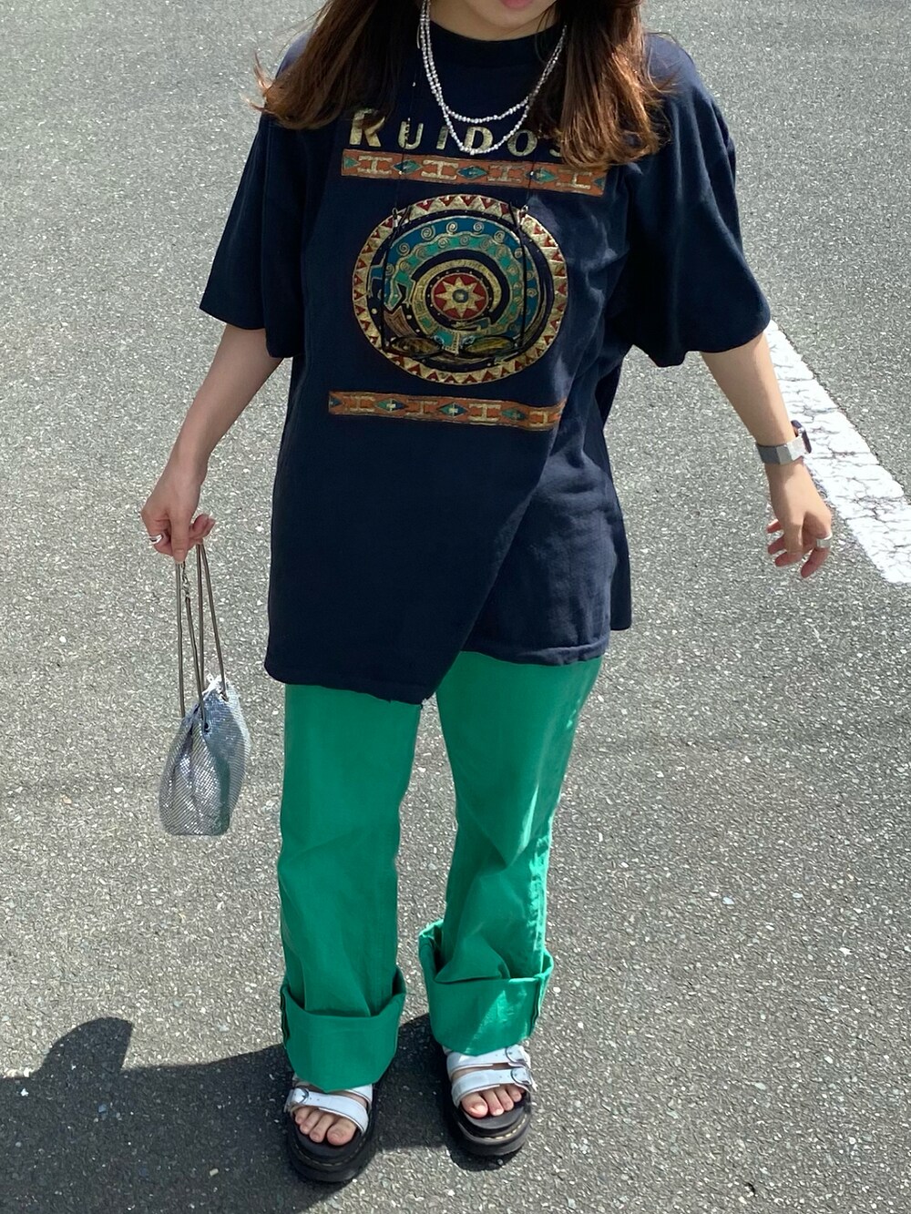 ブラック系のTシャツ/カットソー、グリーン系のデニムパンツ、ホワイト系のサンダルを着用したレディースの夏コーディネートの2枚目の写真