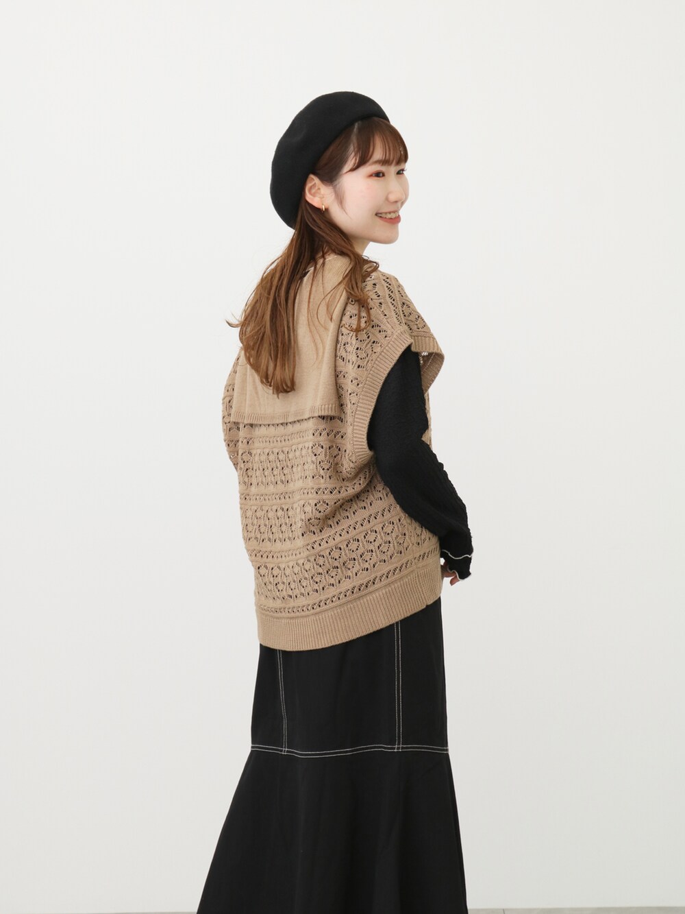 ベージュ系のベスト、ブラック系のスカート、ブラック系のその他シューズを着用したレディースの春コーディネートの3枚目の写真