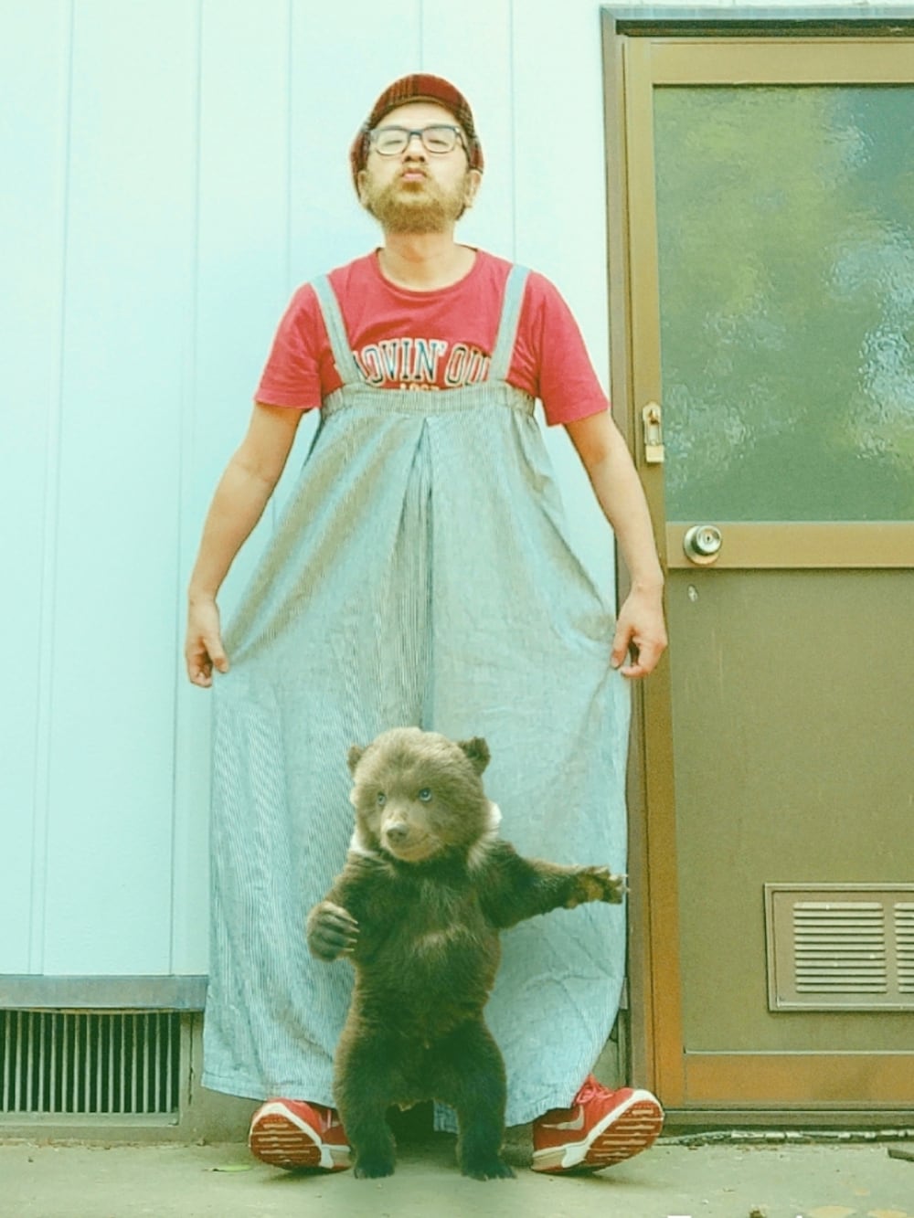 レッド系のTシャツ/カットソー、レッド系のスニーカー、グレー系のサロペット/オーバーオールを着用したメンズの春コーディネートの2枚目の写真