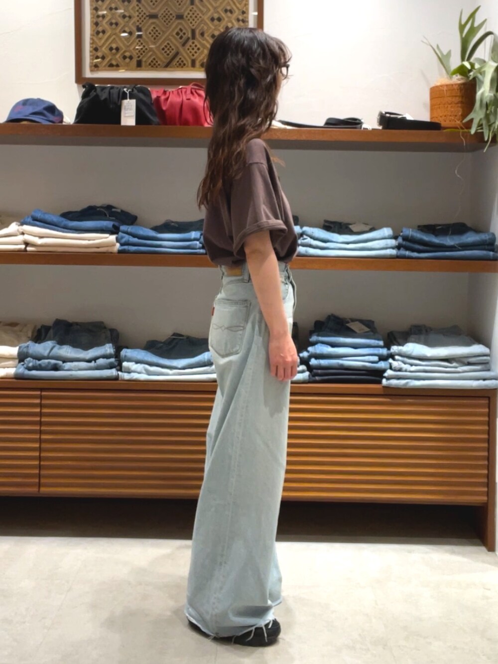 ブラウン系のTシャツ/カットソー、ブルー系のデニムパンツを着用したレディースの夏コーディネートの4枚目の写真
