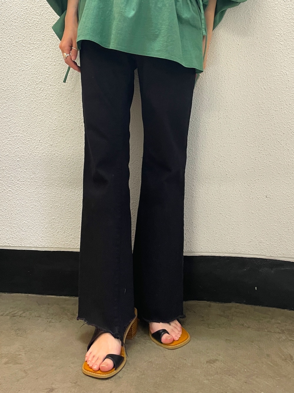 グリーン系のシャツ/ブラウス、ブラック系のデニムパンツ、ブラック系のサンダルを着用したレディースの春コーディネートの4枚目の写真