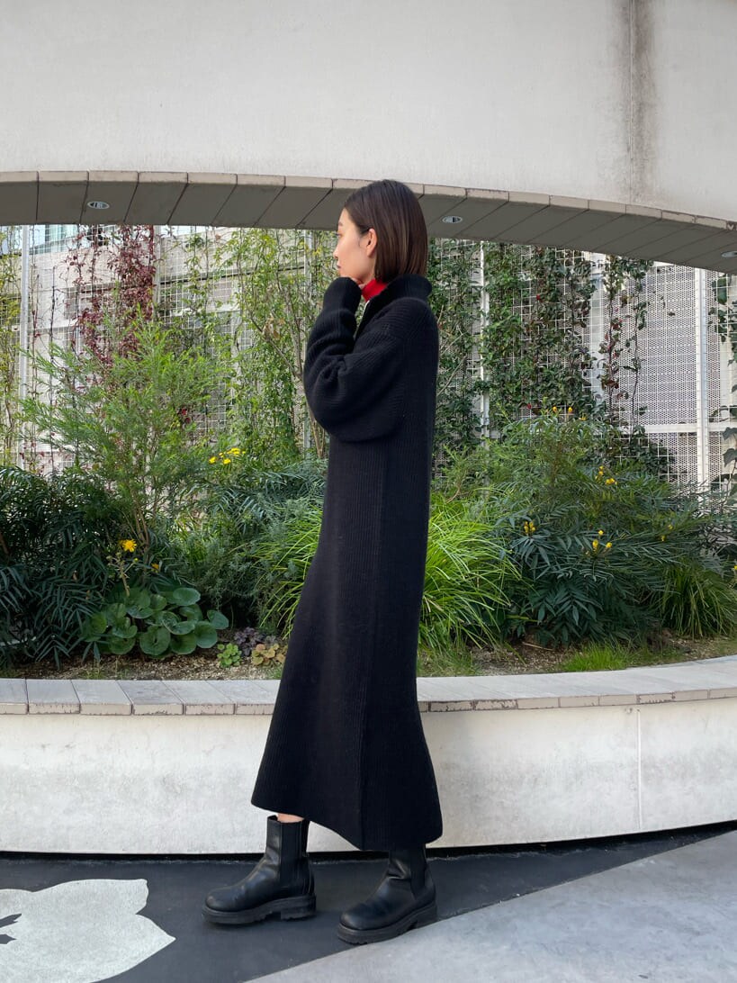 レッド系のニット/セーター、ブラック系のワンピースを着用したレディースの冬コーディネートの2枚目の写真