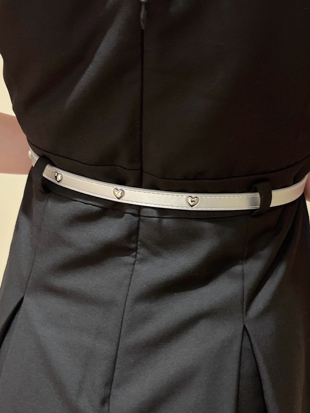 ブラック系のワンピース、ホワイト系のTシャツ/カットソー、ブラック系のサンダルを着用したレディースの春コーディネートの6枚目の写真