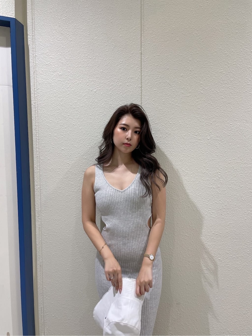 ホワイト系のサンダル、グレー系のワンピース、ホワイト系のハットを着用したレディースの夏コーディネートの7枚目の写真