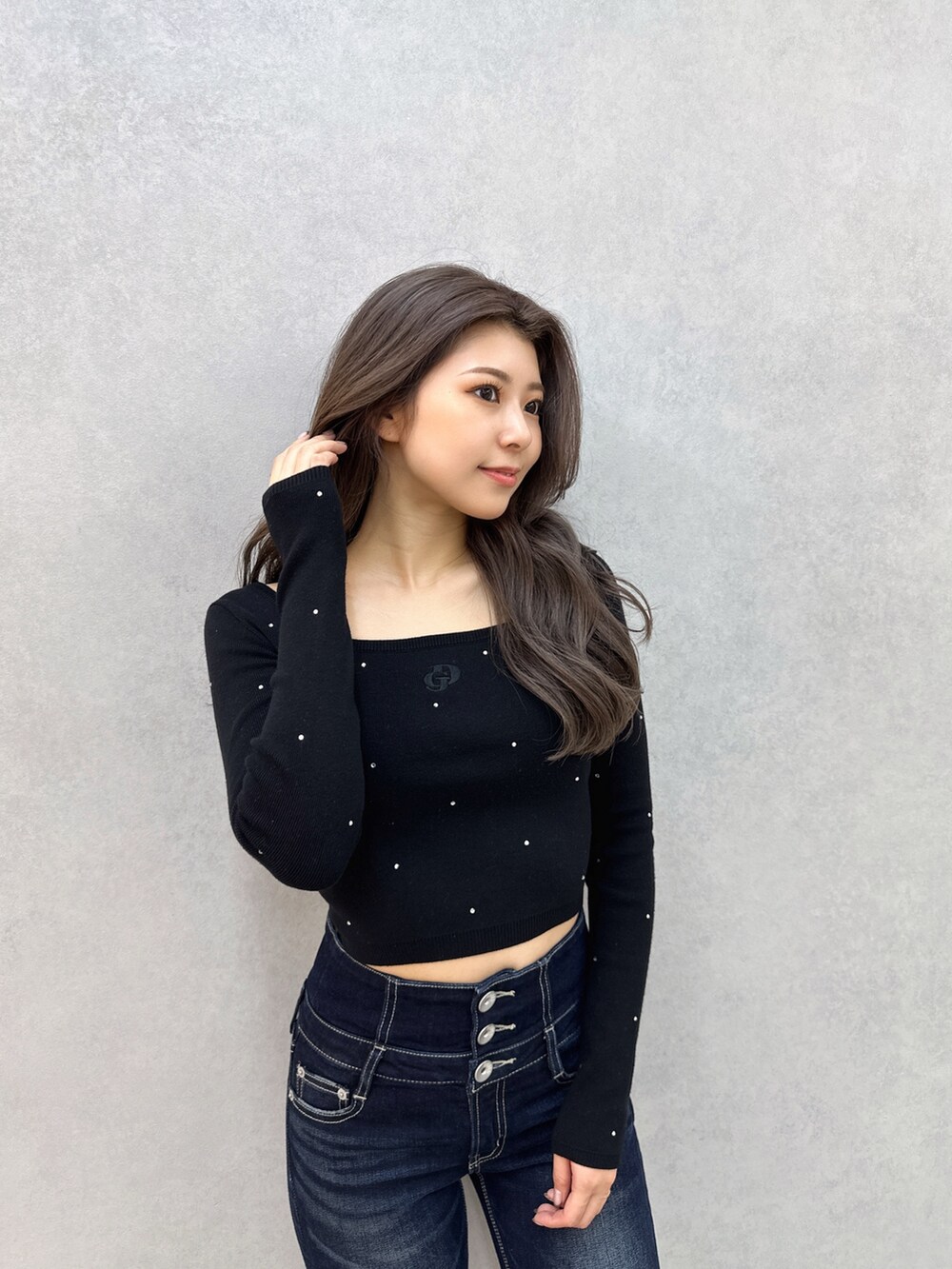 ブルー系のデニムパンツ、ブラック系のブーツ、ブラック系のニット/セーターを着用したレディースの冬コーディネートの5枚目の写真