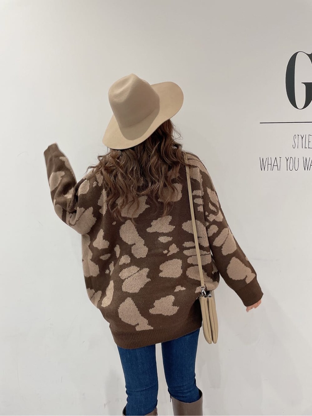 ブラウン系のブーツ、ブルー系のデニムパンツ、ベージュ系のショルダーバッグを着用したレディースの秋コーディネートの6枚目の写真