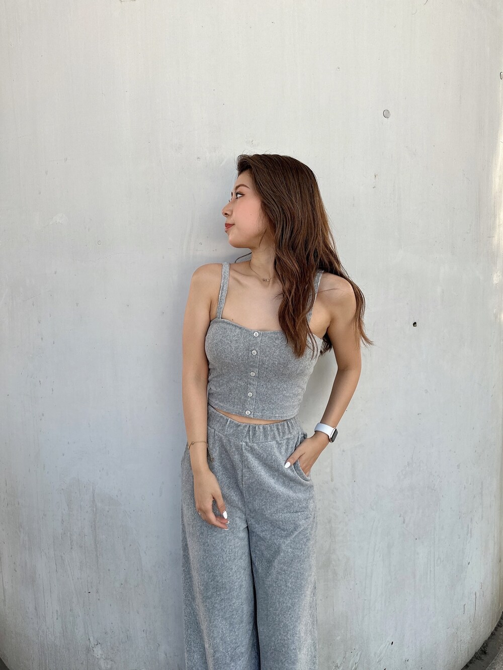 グレー系のキャミソール、ブラック系のスウェットパンツ、ブラック系のパンプスを着用したレディースの夏コーディネートの8枚目の写真