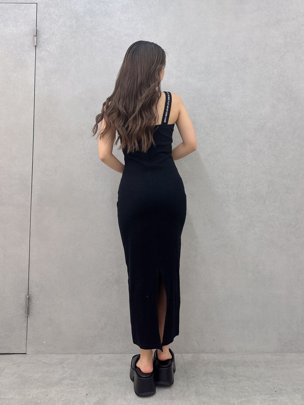 ブラック系のワンピース、ブラック系のサンダルを着用したレディースの夏コーディネートの3枚目の写真