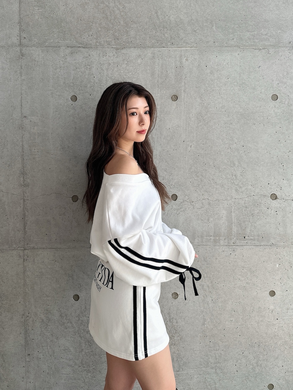 ホワイト系のカーディガン/ボレロ、ホワイト系のスカート、ブラック系のブーツを着用したレディースの秋コーディネートの4枚目の写真