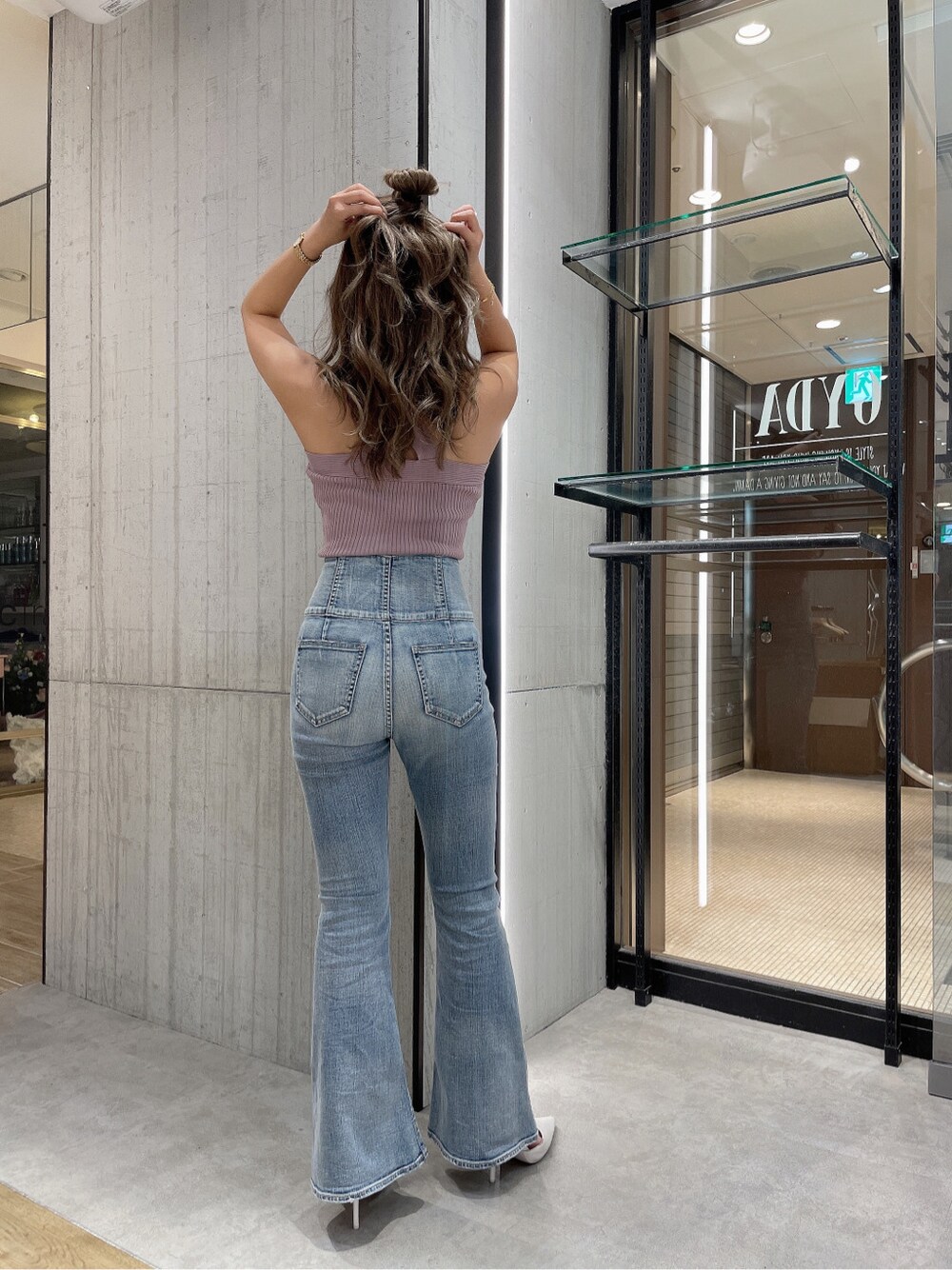 ブルー系のデニムパンツ、ピンク系のタンクトップを着用したレディースの春コーディネートの3枚目の写真