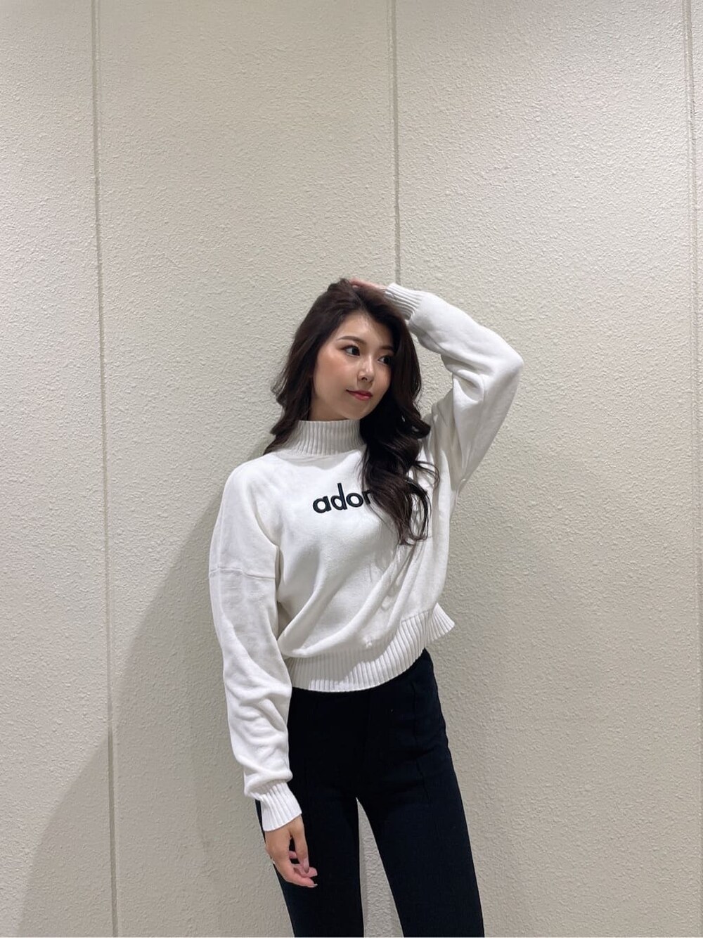 ブラック系のブーツ、ブラック系のダウンジャケット/コート、ホワイト系のニット/セーターを着用したレディースの秋コーディネートの8枚目の写真