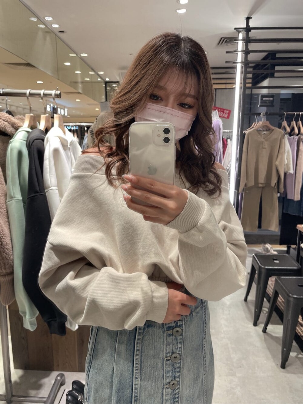 ブラック系のパンプス、ブルー系のデニムスカート、ホワイト系のスウェットを着用したレディースの冬コーディネートの2枚目の写真